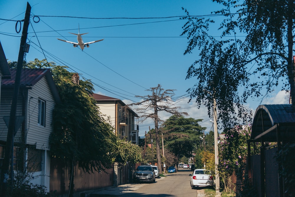 an airplane is flying over a residential area