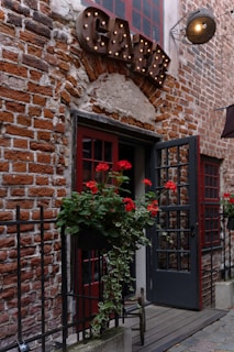 a red brick building with a black door and window