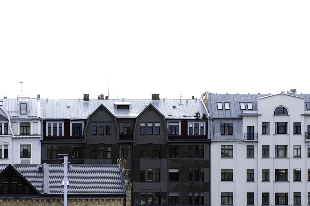 a row of buildings with a clock tower in the middle