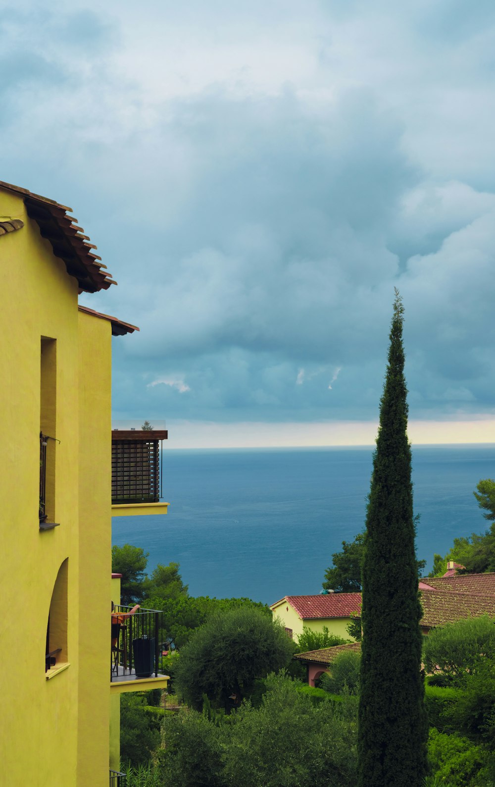 a yellow building with a view of the ocean