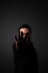 a man holding his hand up in the air