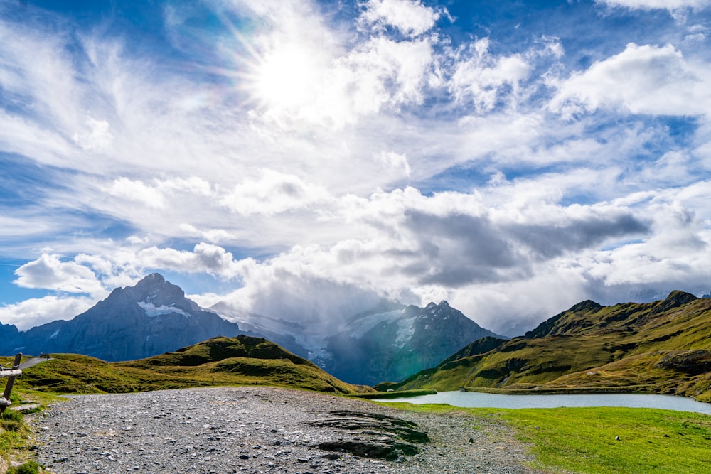 a scenic view of a mountain range with a lake in the foreground