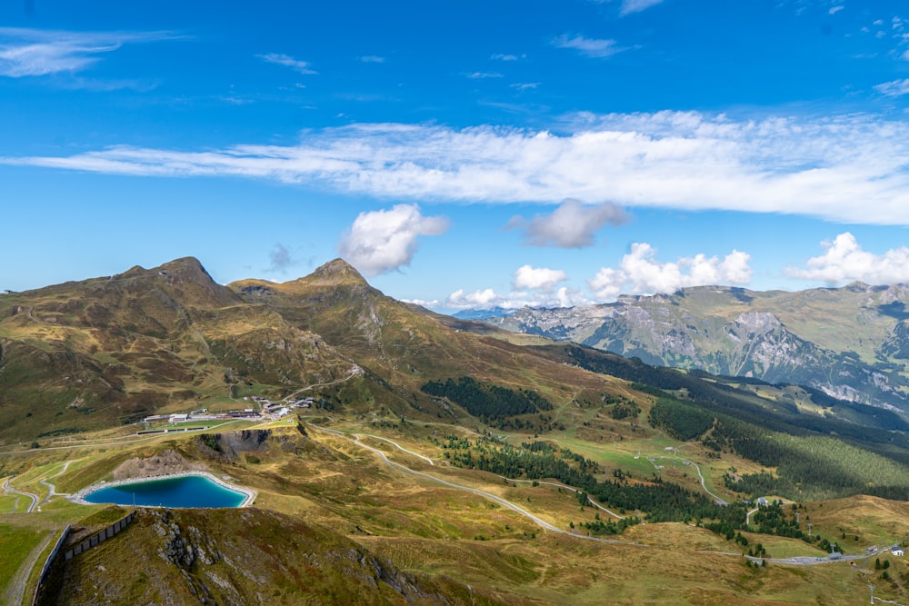 a scenic view of a mountain range with a lake in the foreground