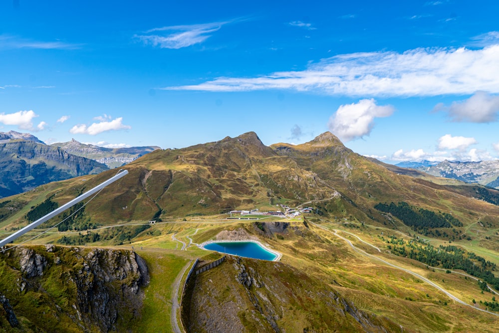 a scenic view of a mountain range with a lake in the middle