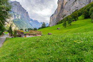 A serene mountain landscape in the Alps with hikers enjoying a sunny day.