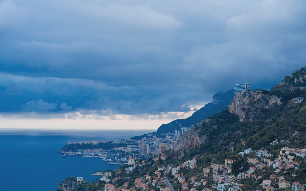 a view of a city on a cliff overlooking the ocean