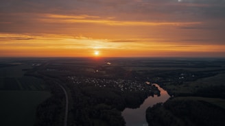 A serene riverside village at sunset, showcasing an untouched Indian landscape.