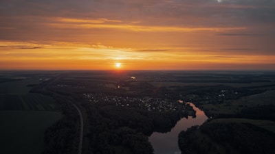 A serene riverside village at sunset, showcasing an untouched Indian landscape.