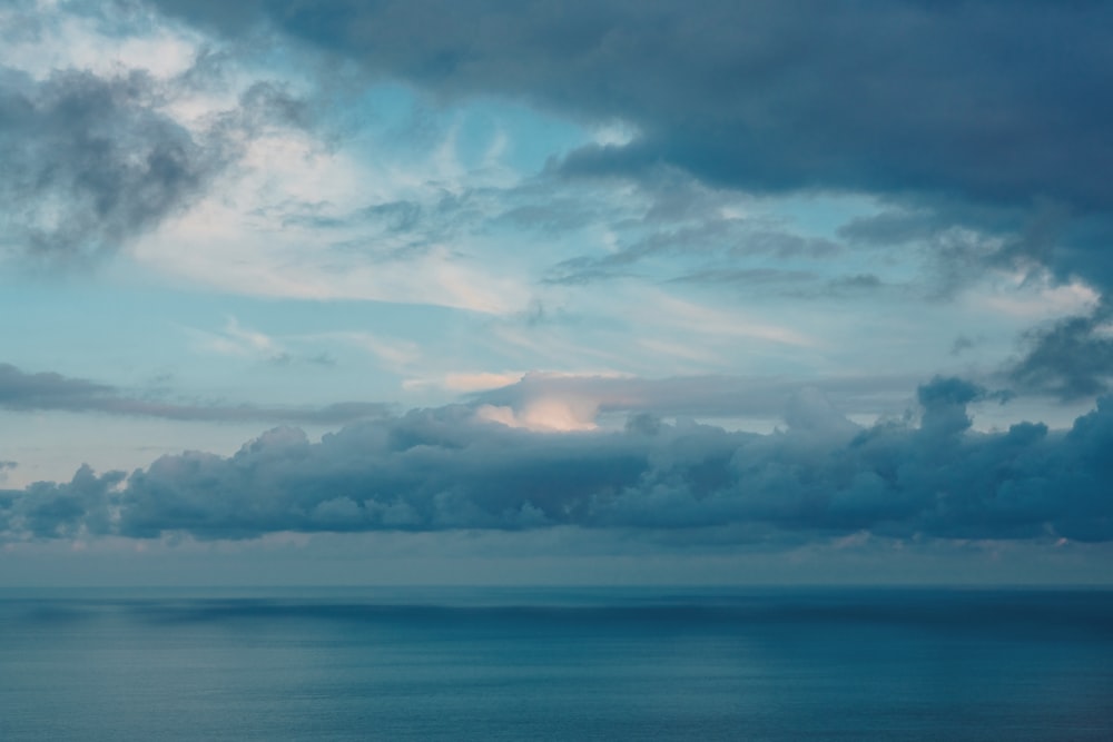 a large body of water under a cloudy sky