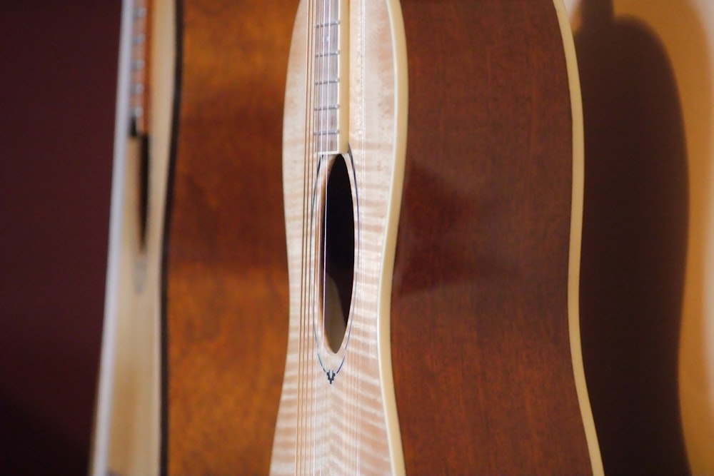 a close up of a guitar with a wooden back and sides