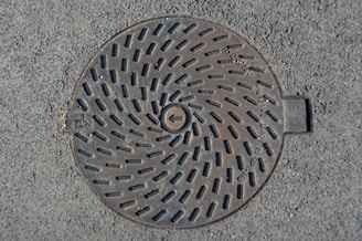 a manhole cover in the middle of the road