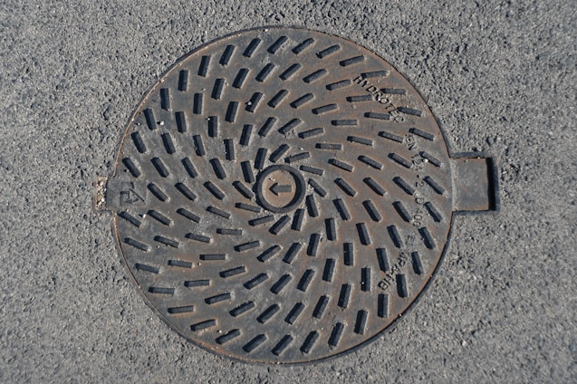 a manhole cover in the middle of the road