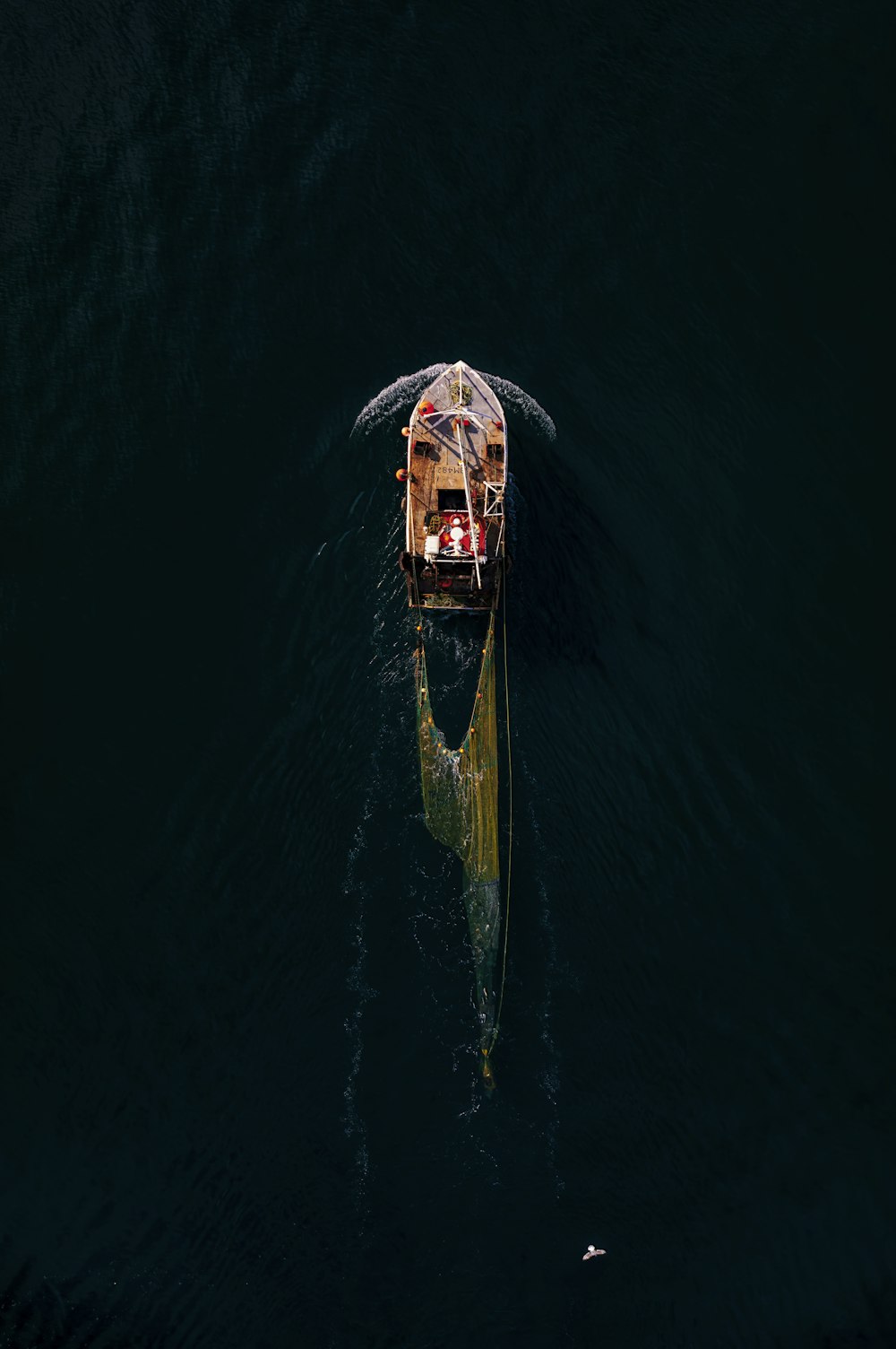 a small boat floating on top of a large body of water