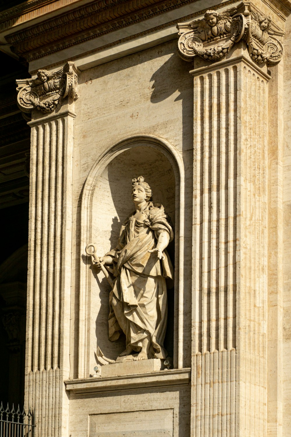 a statue of a woman holding a bird on top of a building