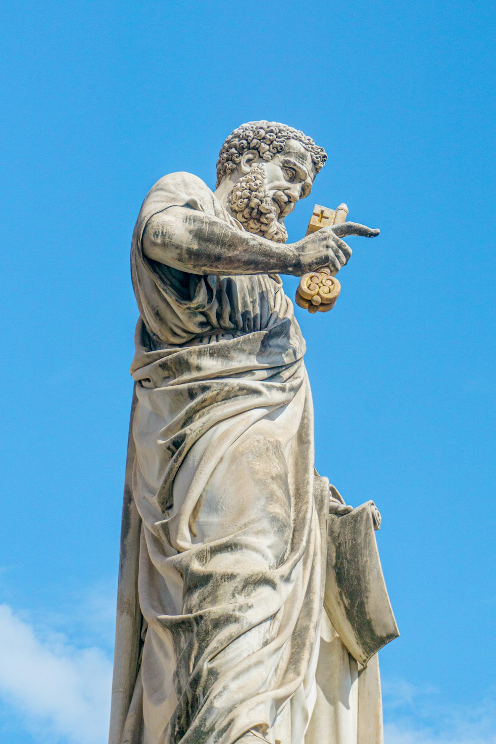 a statue of a person holding a piece of food