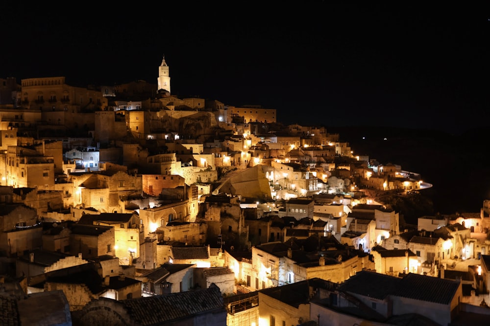 a night view of a city with a clock tower