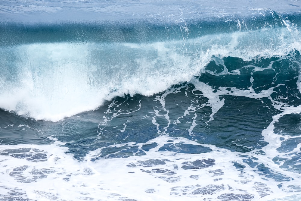 a person riding a surfboard on a wave in the ocean