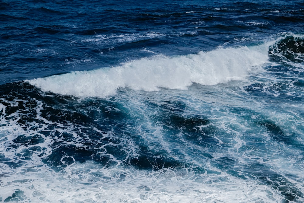 a large body of water with a wave coming in