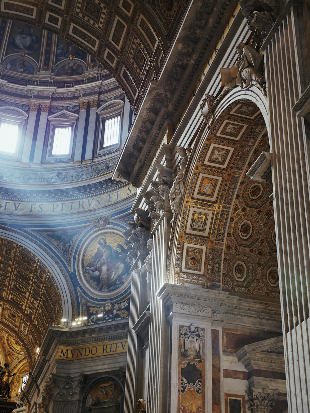 the ceiling of a large building with paintings on it