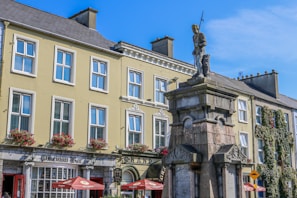 a statue in front of a building with many windows