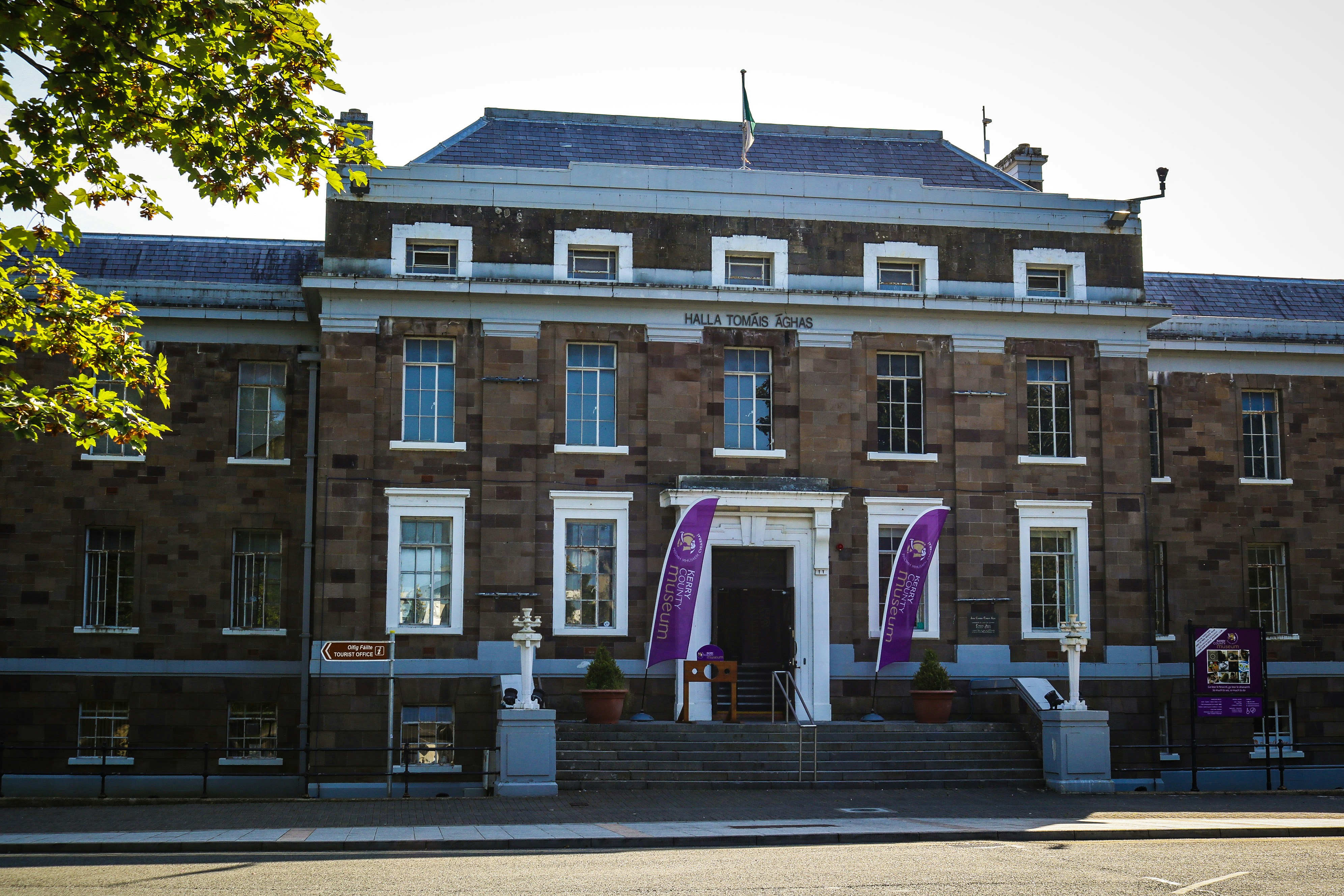 a large brick building with flags on the front of it