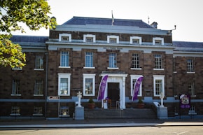 a large brick building with flags on the front of it