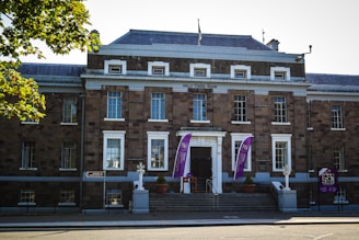 a large brick building with flags on the front of it