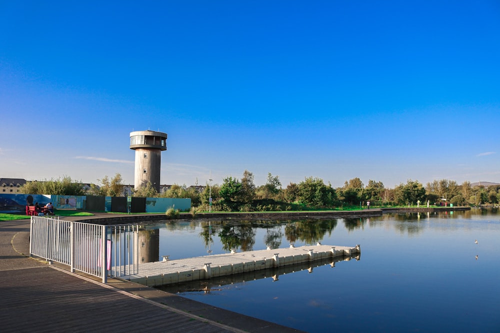 a large body of water with a tower in the background