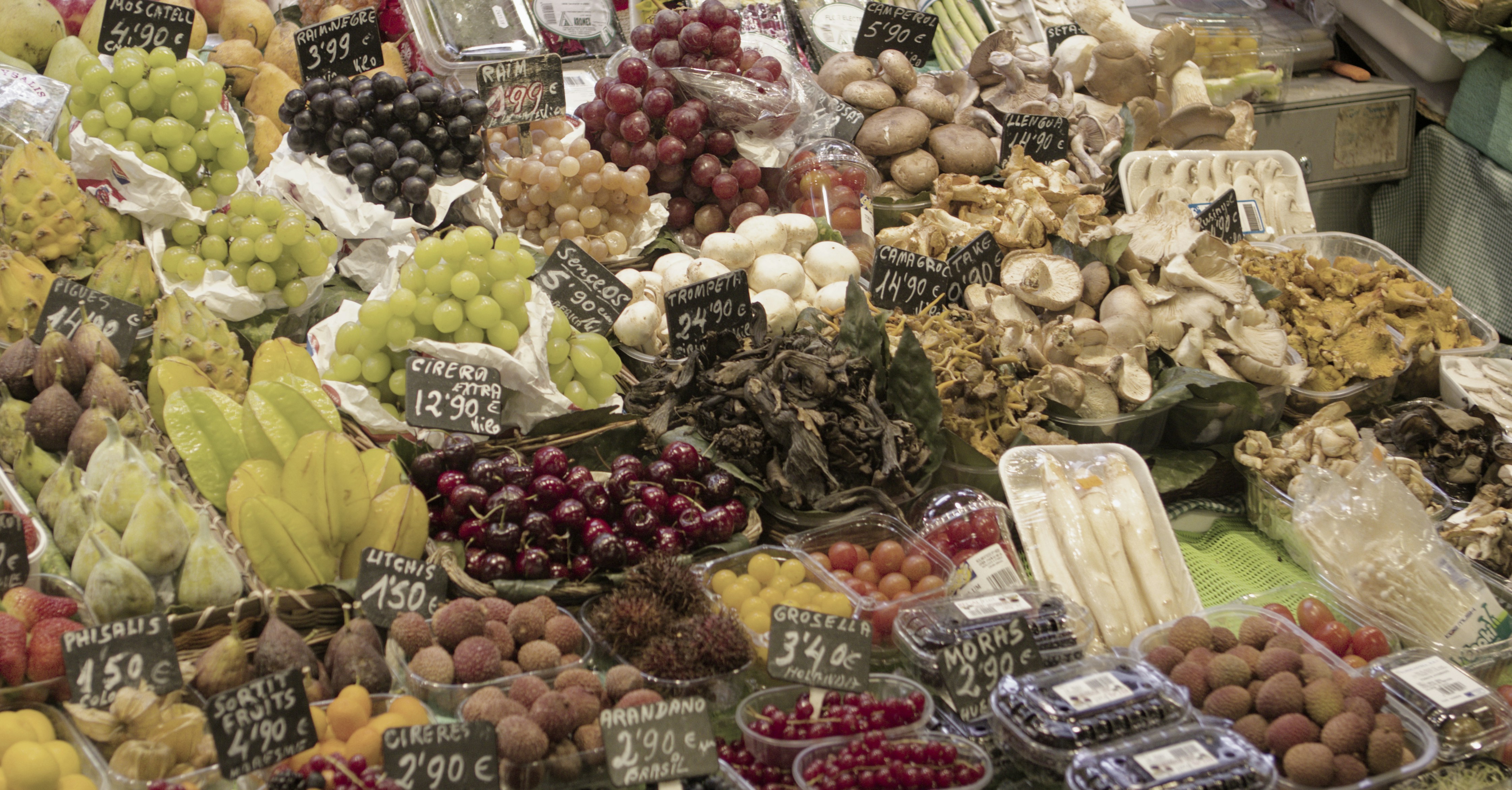 a large display of fruits and vegetables for sale
