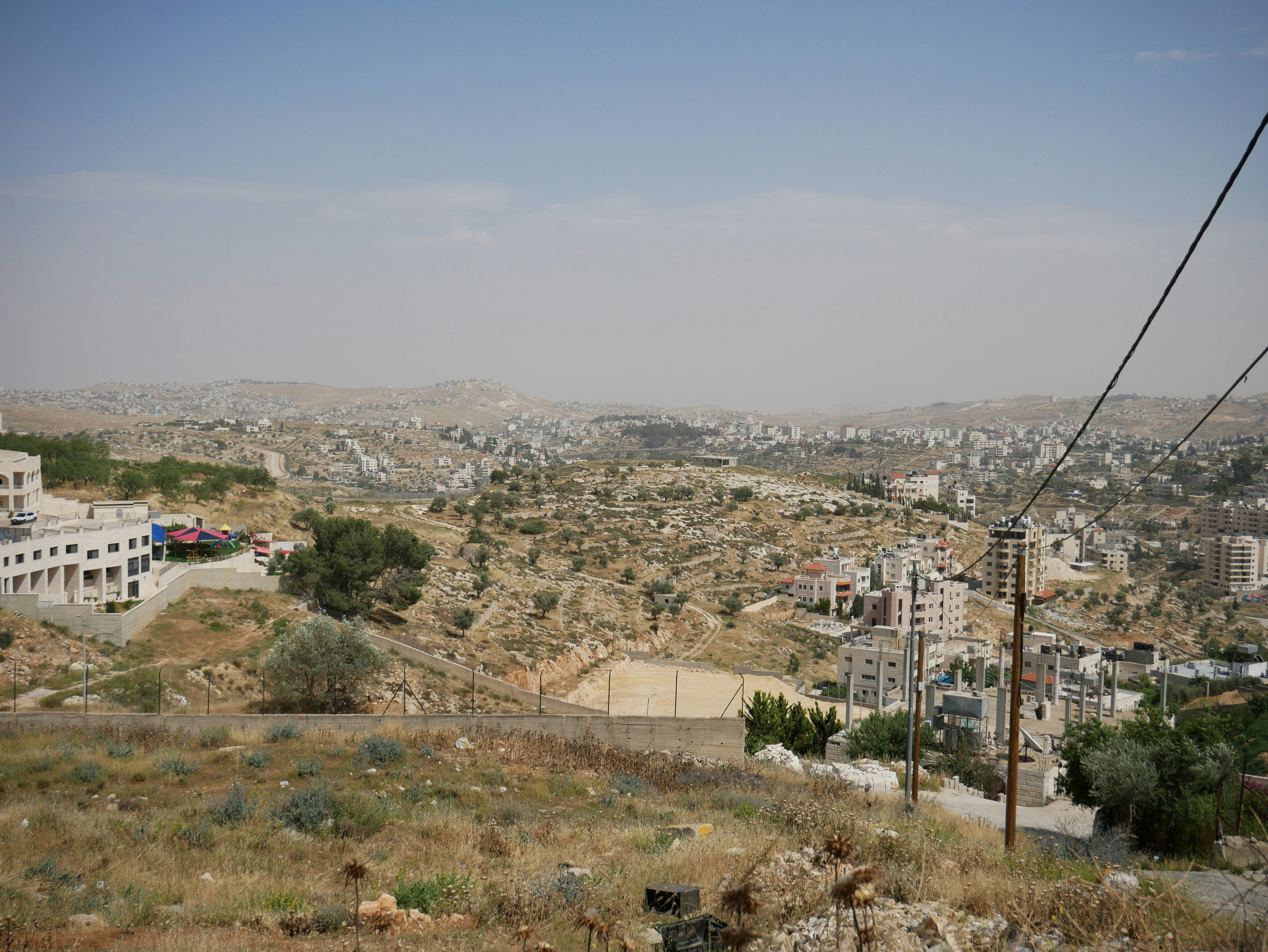 a view of a city from the top of a hill