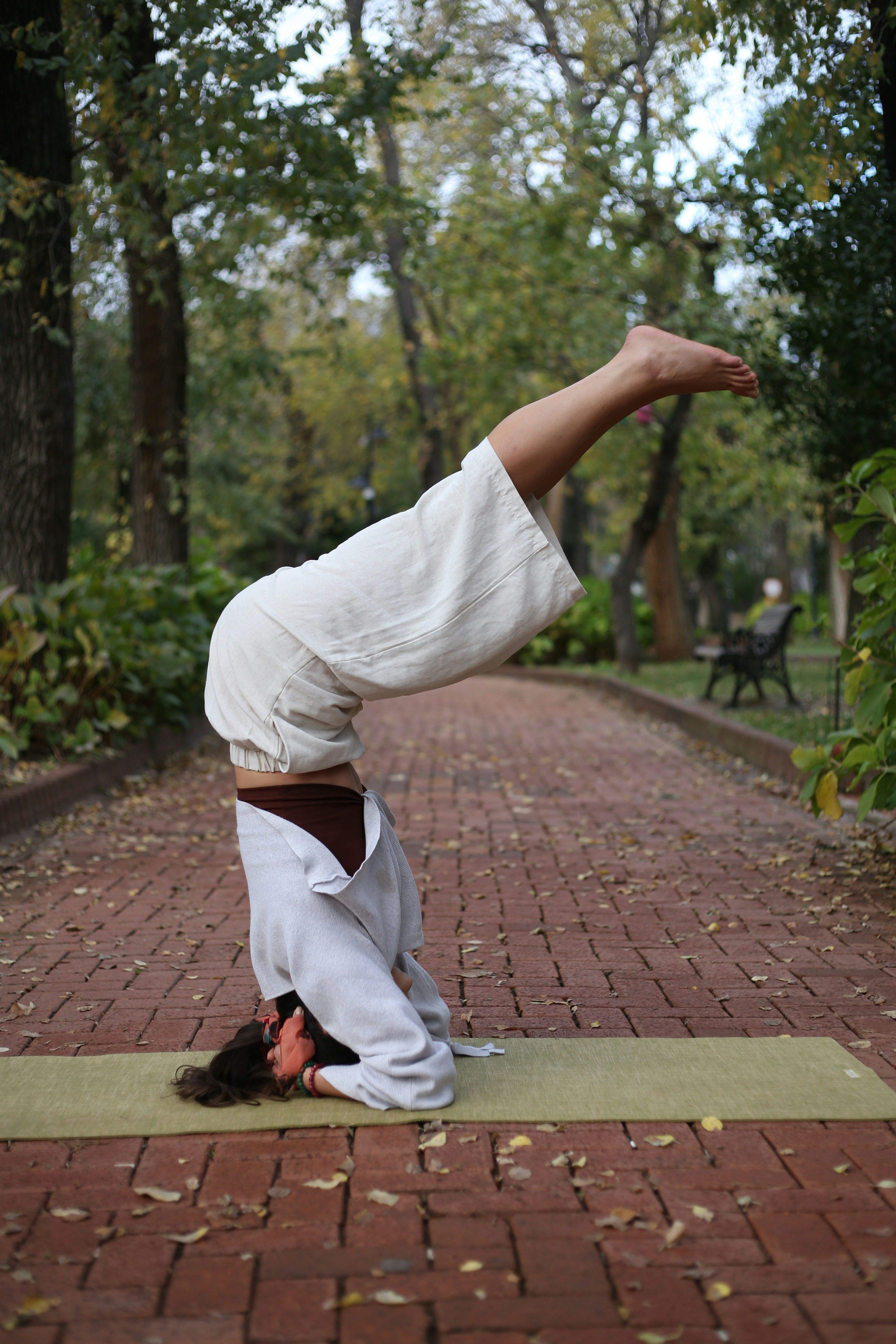 a man doing a handstand in a park