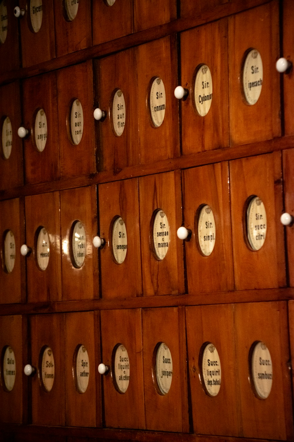 a wall of wooden doors with white knobs