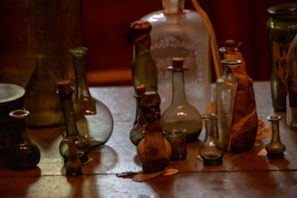 A collection of custom glass jars and bottles showcasing different shapes and sizes on a wooden table.