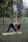 new book coming soon image with a woman doing a yoga pose in a park