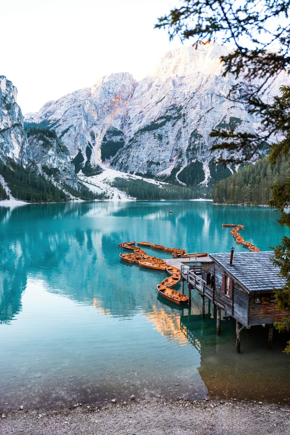 a lake with a dock and mountains in the background