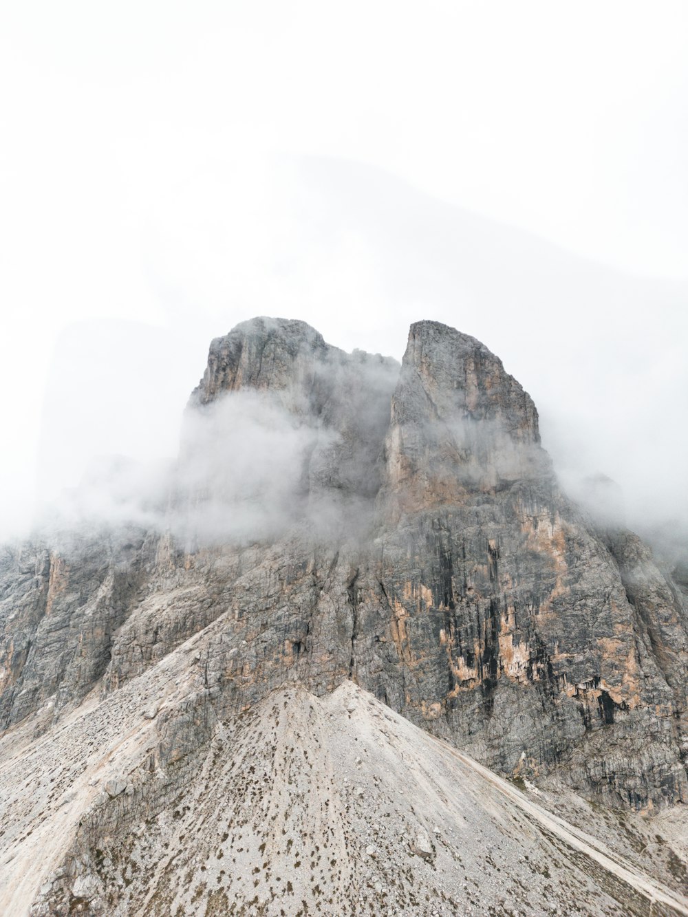 a very tall mountain with some clouds in the air