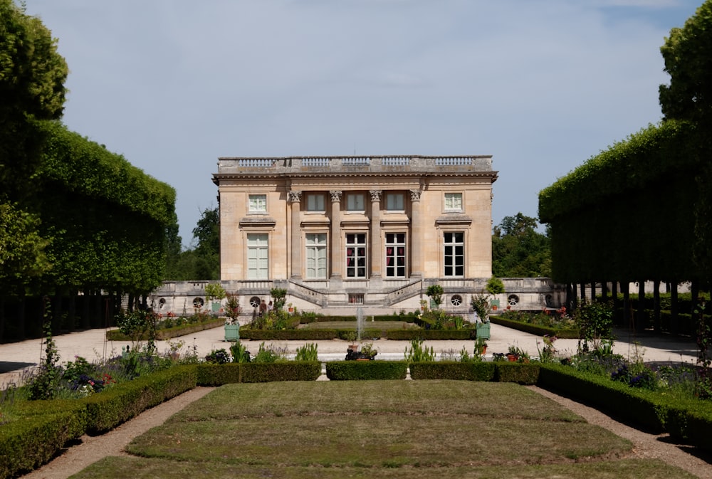 a large building with a garden in front of it