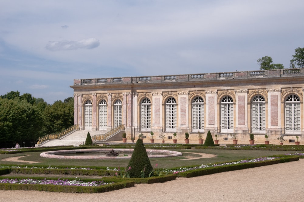 a large building with a garden in front of it