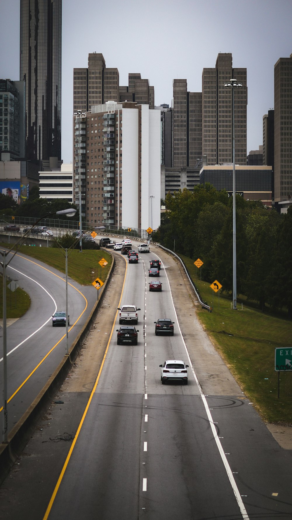 a highway with a bunch of cars driving down it