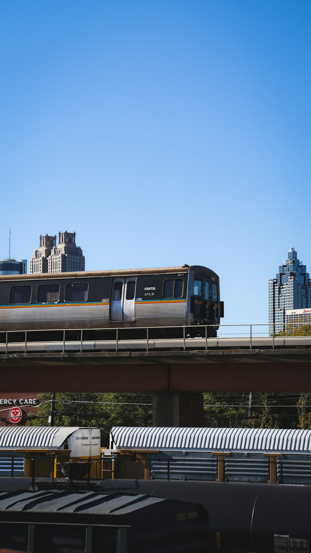 um trem viajando sobre uma ponte em uma cidade