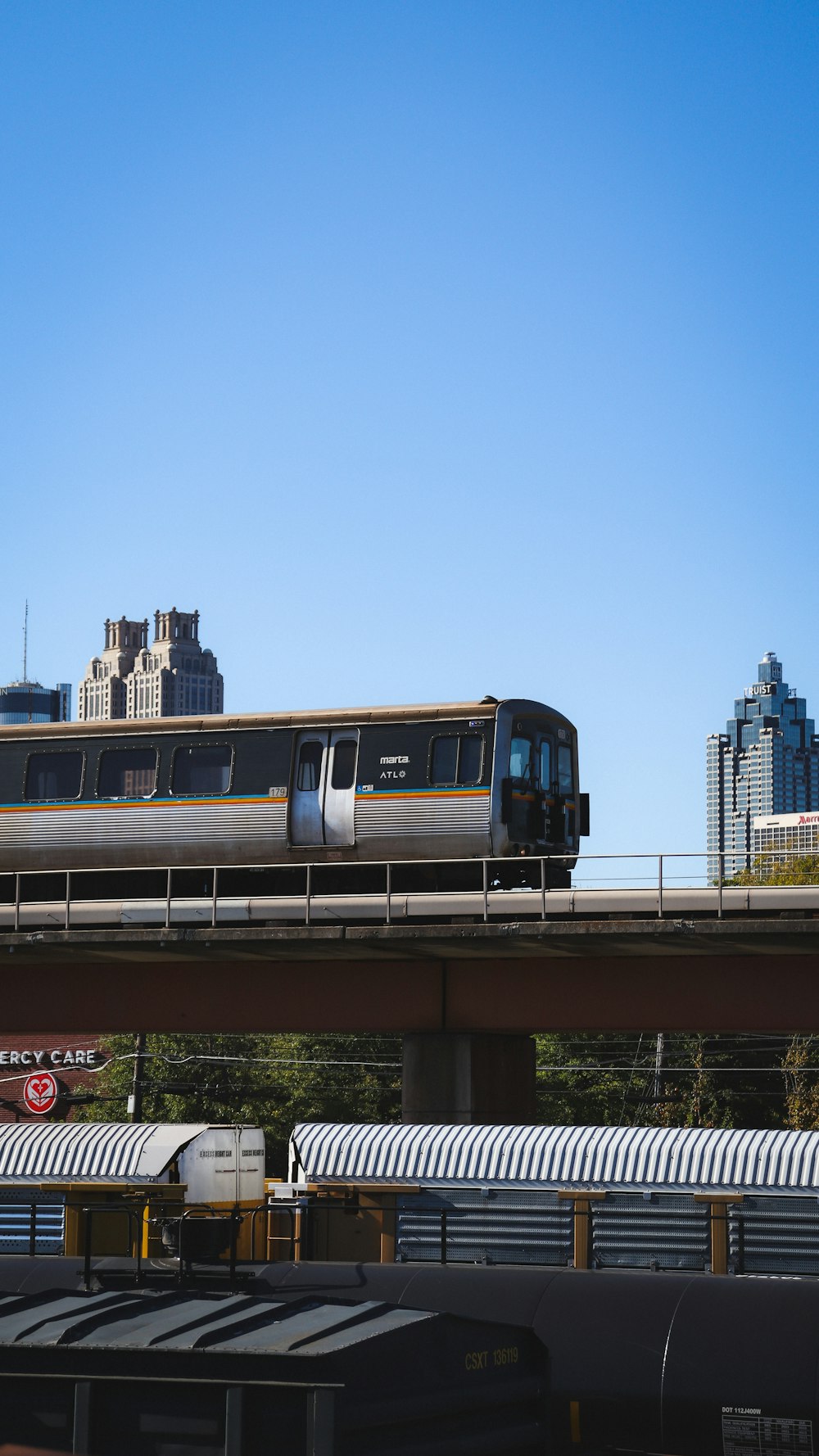 a train traveling over a bridge in a city