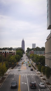 a city street with a tall building in the background