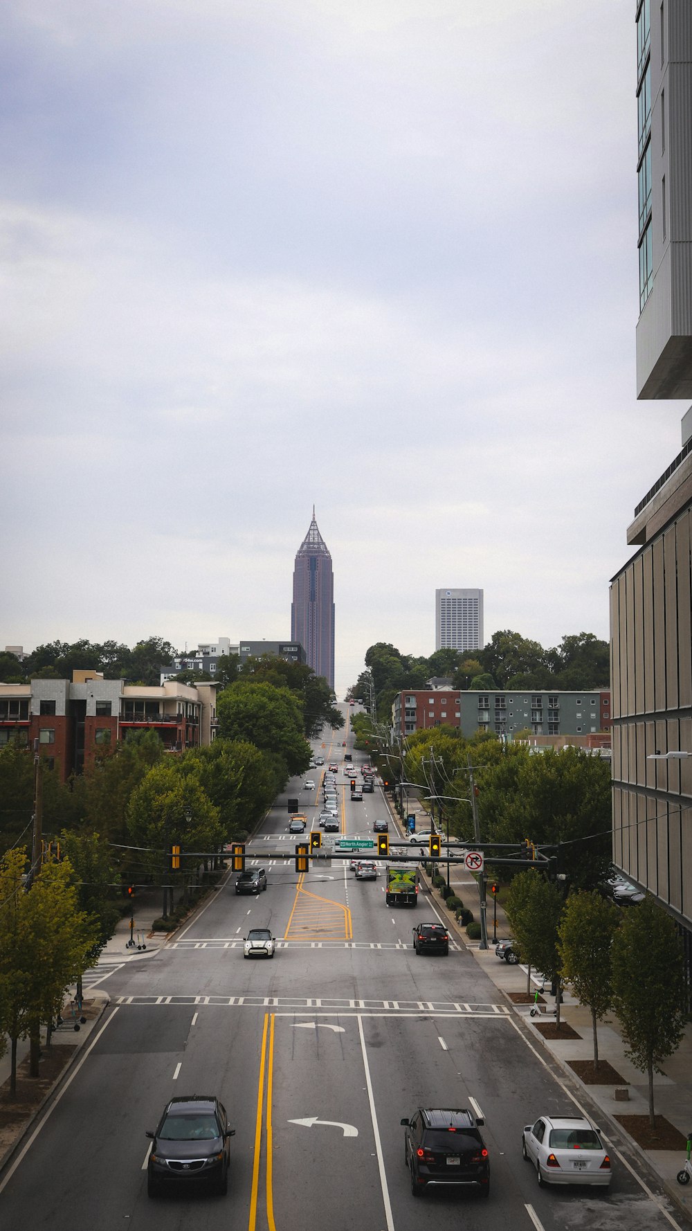 a city street with a tall building in the background