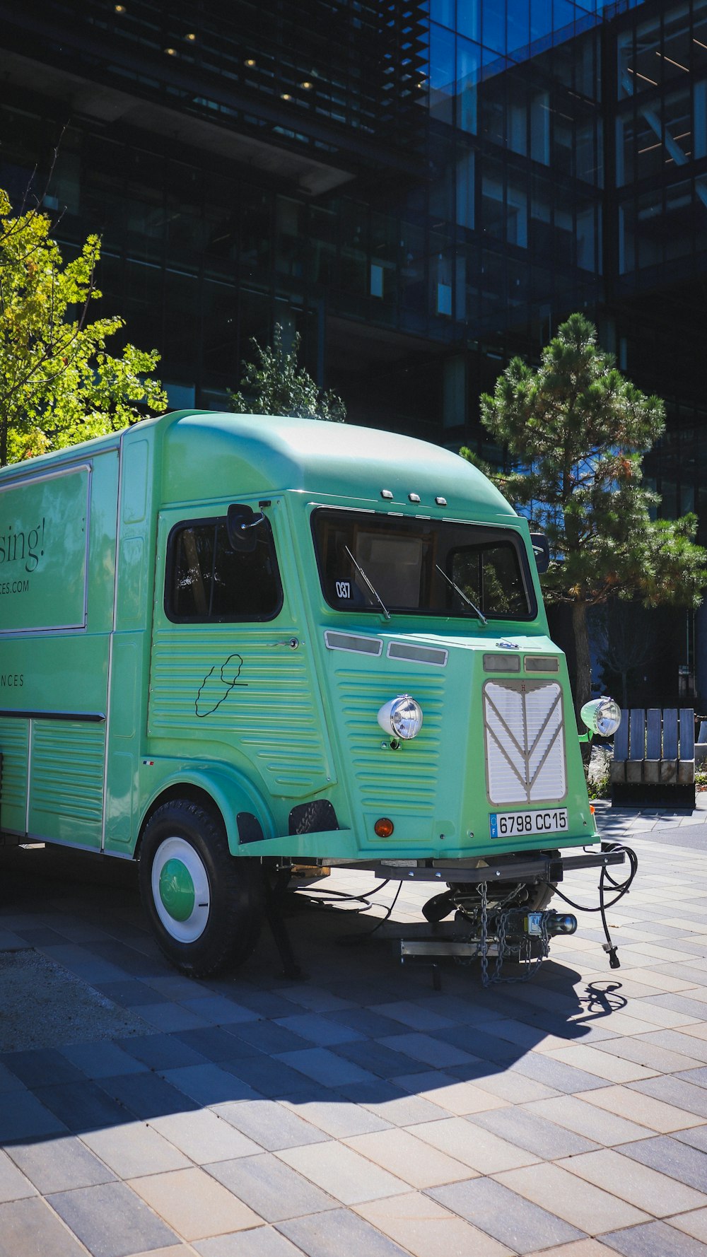 a green food truck parked on the side of the road