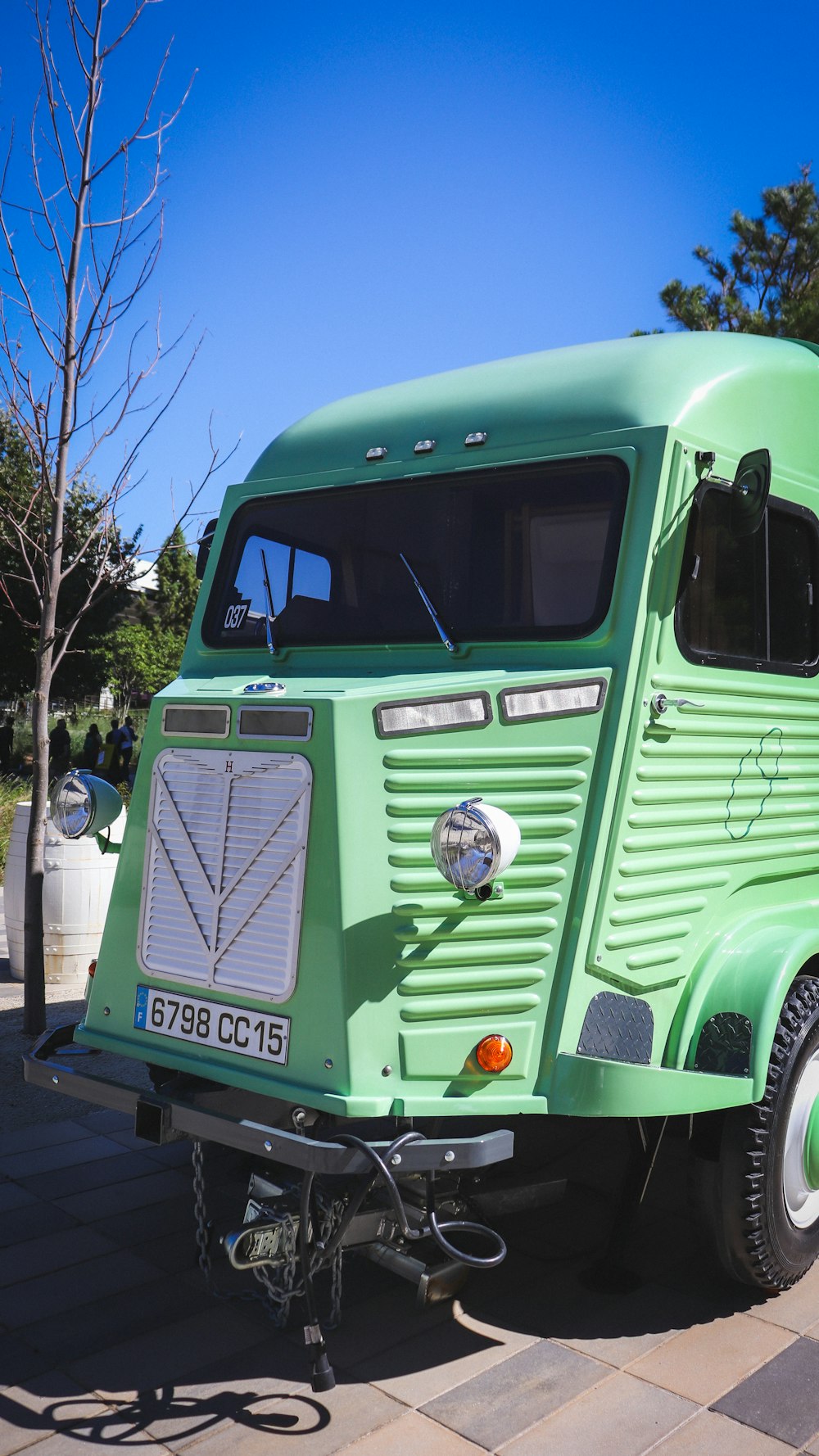 a green truck parked on the side of the road