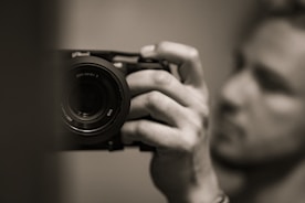A person holding a camera, symbolizing original photography.