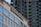 A modern building with the sign 'Northside Medical' prominently displayed. The structure features large glass windows reflecting the light. In the background, there is a high-rise apartment building with numerous balconies and windows, showcasing an urban setting.