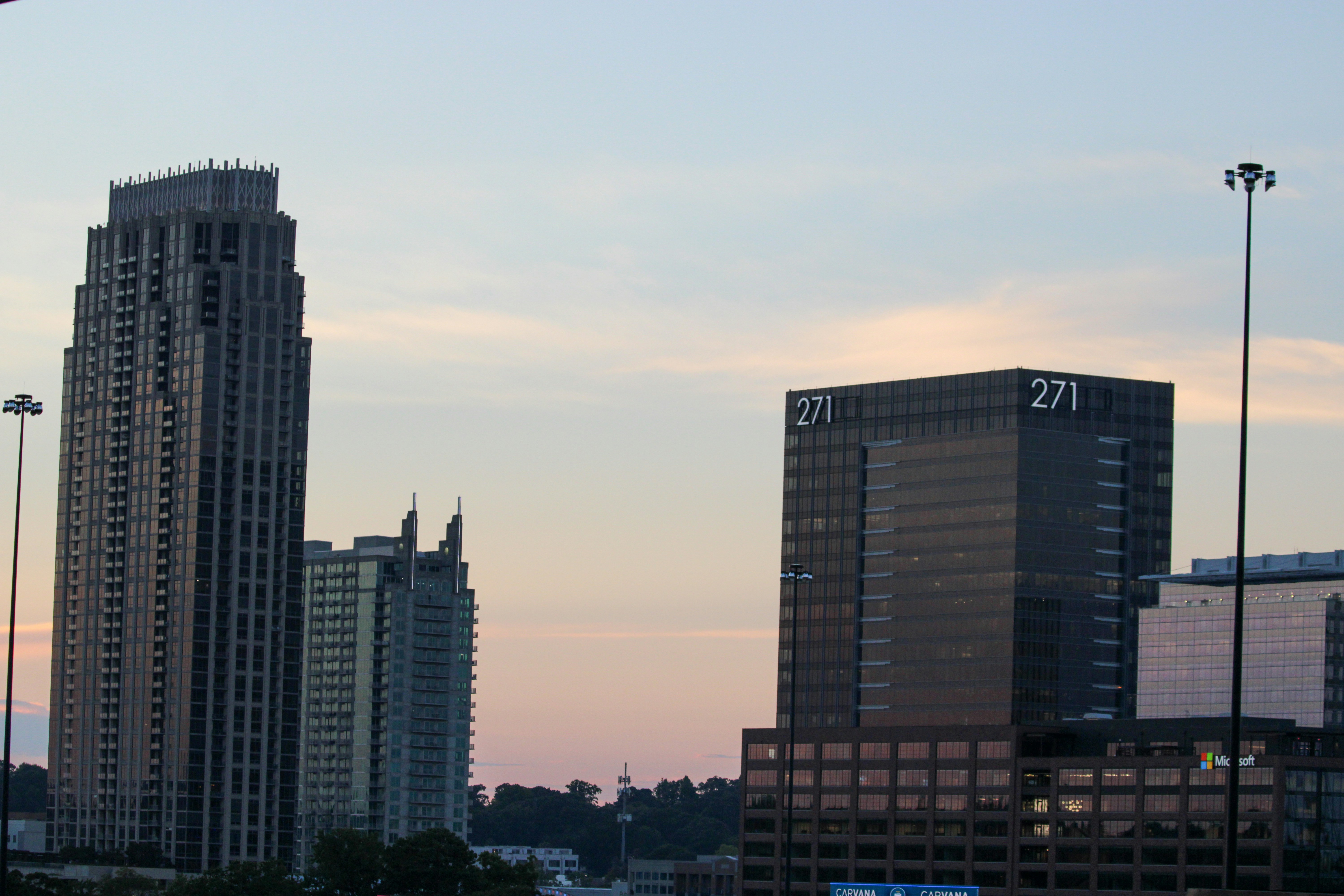 a couple of tall buildings sitting next to each other