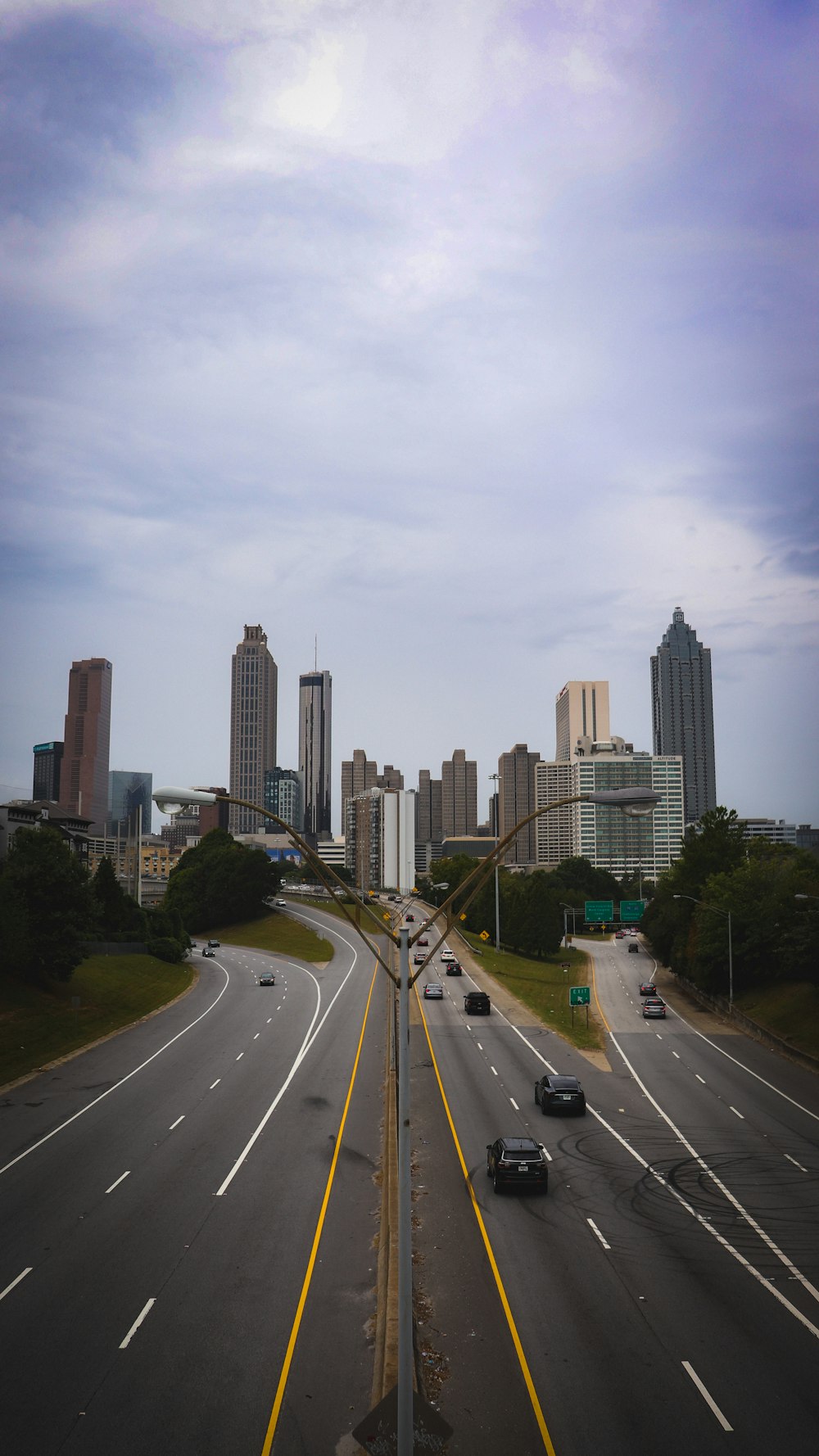 a highway with a bunch of cars driving down it