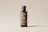 A sleek, cylindrical bottle with a minimalist design stands against a light neutral background. The label on the bottle reads 'Bottle Duo' in white text, and there is a QR code printed below it. The bottle's color is a muted brown with a black cap, and additional text is displayed vertically along the side.